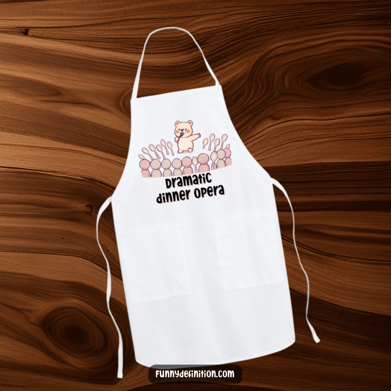 Funny kitchen apron showing a tiny bear dramatically singing opera to a bewildered audience of spoons, for humorous culinary performances.