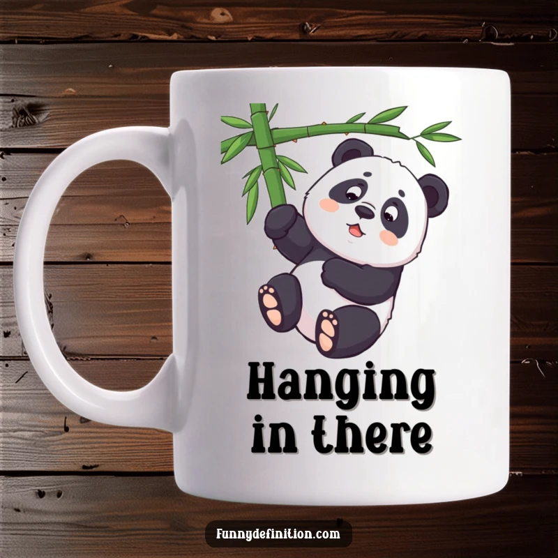 Funny panda attempting to hang upside down from a bamboo branch on a humorous mug.