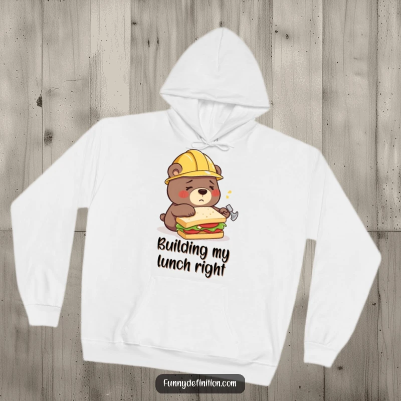 Funny hoodie with a confused bear wearing a construction helmet, hilariously attempting to build a sandwich using a hammer, a true DIY disaster.
