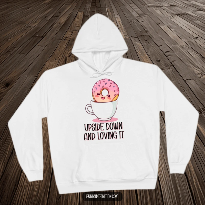 Funny hoodie design showing a giggling donut with sprinkles taking an inverted plunge into a coffee cup.