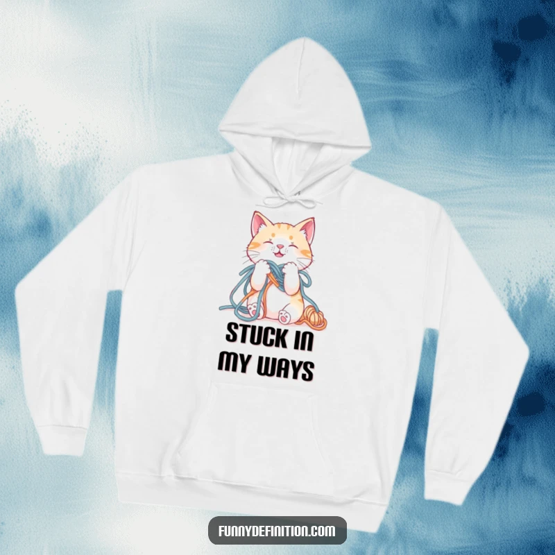 Funny hoodie featuring a cat hilariously entangled in a ball of yarn, looking slightly panicked but cute.