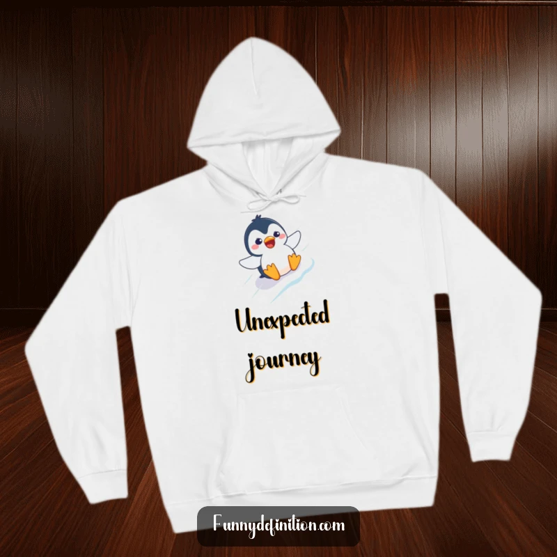 Funny hoodie graphic of a penguin with a comically surprised expression, sliding rapidly down an icy slope.