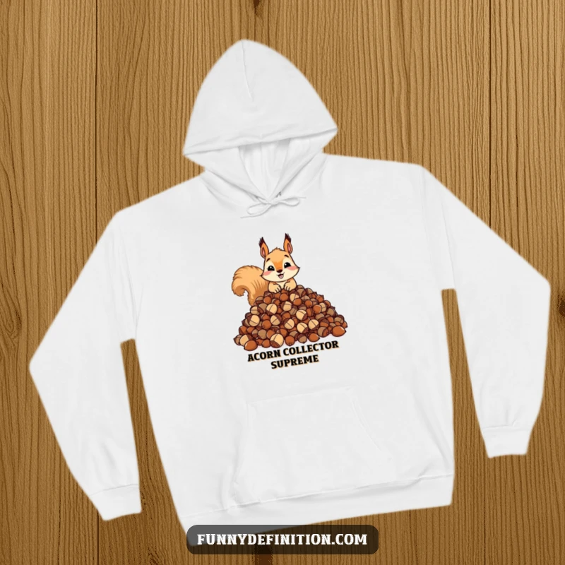 Funny hoodie showing a squirrel possessively guarding an enormous pile of acorns. Cozy and comical design.