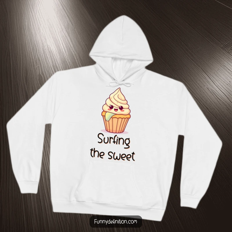 Funny hoodie featuring a surprised cupcake with frosting sliding down a vibrant rainbow, radiating joy.