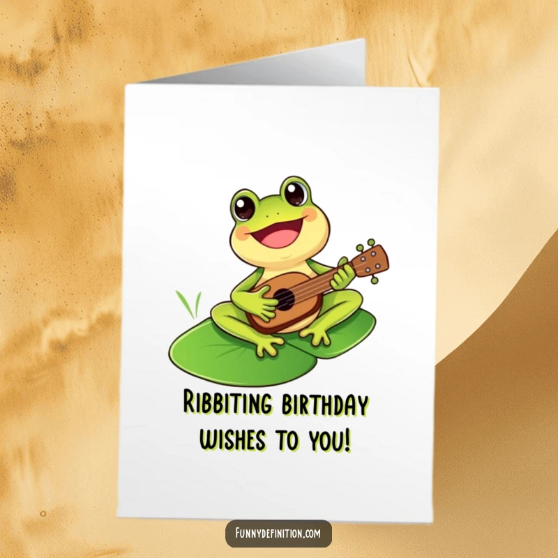Funny Free Printable Birthday Card: A happy frog strumming a tiny ukulele on a lily pad, ready to party.